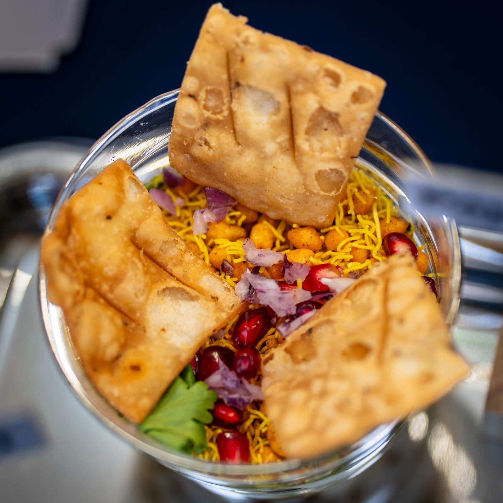 Indian chaat with crisp pastry and garnishes